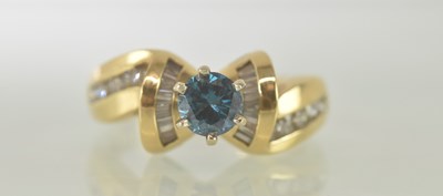 Lot 468 - A 14ct yellow gold blue diamond set ring, the...