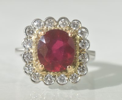 Lot 467 - A white metal ruby and diamond cluster ring,...