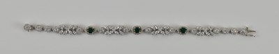 Lot 562 - An 18ct white gold emerald and diamond...