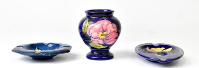 Lot 130 - MOORCROFT; a 'Clematis' pattern oval ashtray,...