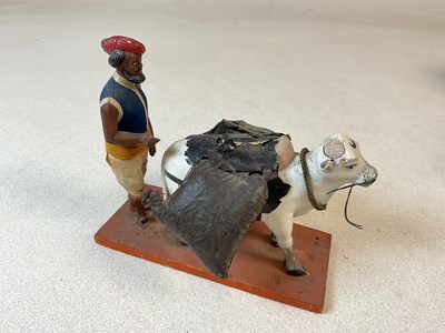 Lot 156 - An Indian folk art figure leading a bull,...