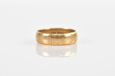 Lot 568 - A 9ct yellow gold band, size R, approximate...