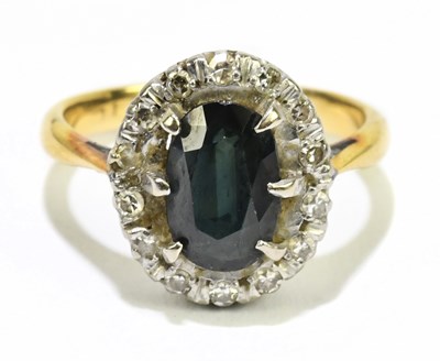 Lot 1053 - An 18ct yellow gold sapphire and diamond oval...