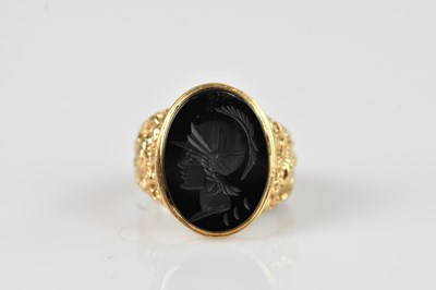 Lot 2526 - A yellow metal signet ring set with a carved...