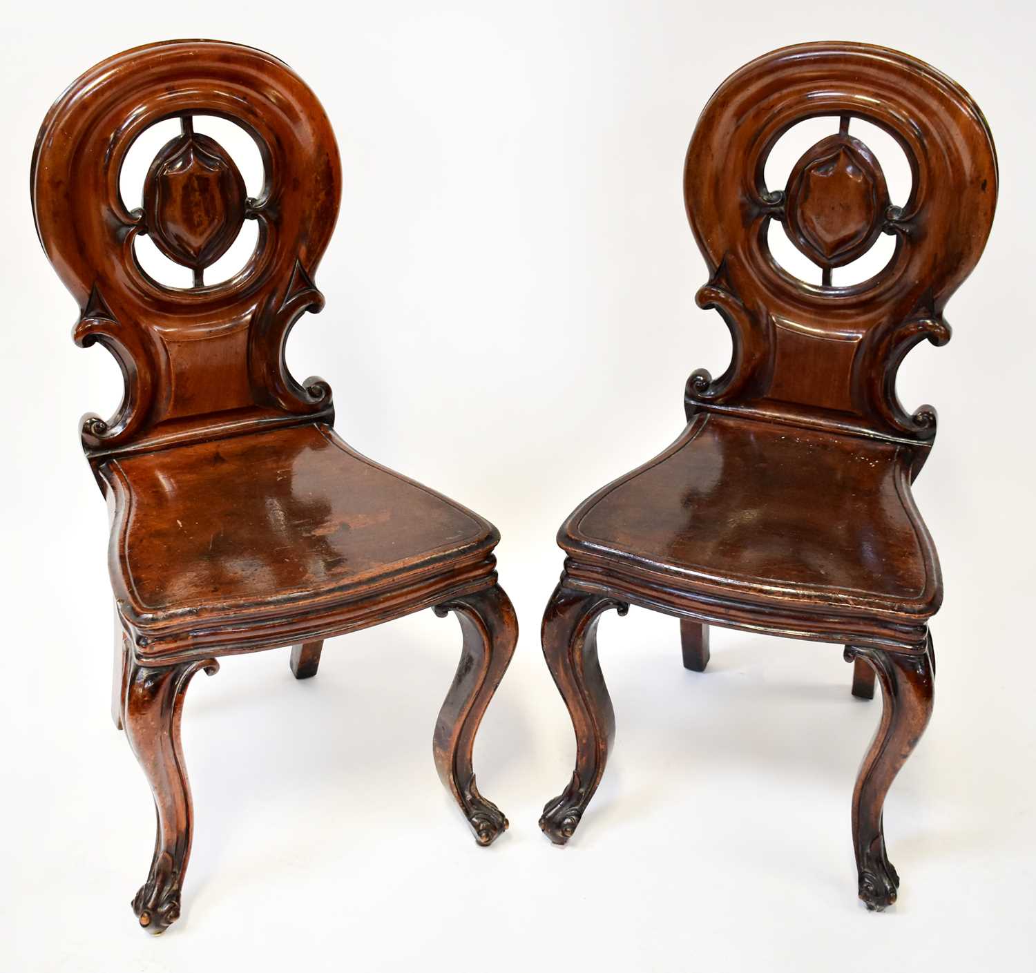 Lot 18 - A pair of Victorian mahogany hall chairs, with...