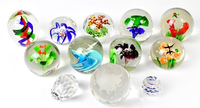 Lot 221 - A collection of twelve glass paperweights, to...