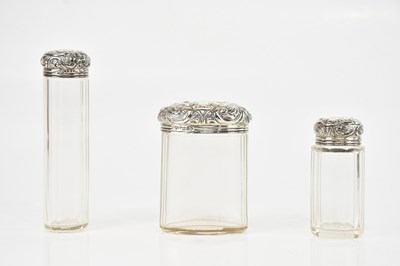 Lot 393 - Three cut glass dressing table bottles with...