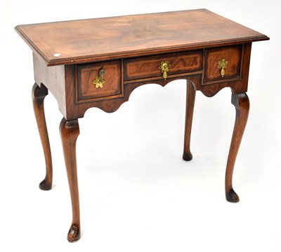 Lot 20 - A reproduction walnut and mahogany lowboy, the...