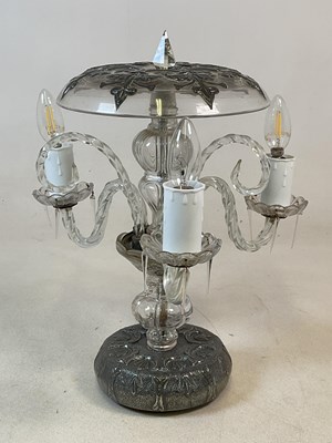 Lot 709 - An unusual clear glass and metal clad lamp,...