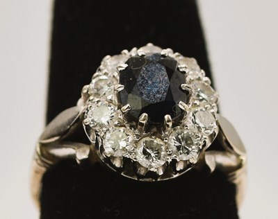 Lot 772 - A white metal sapphire and diamond oval...