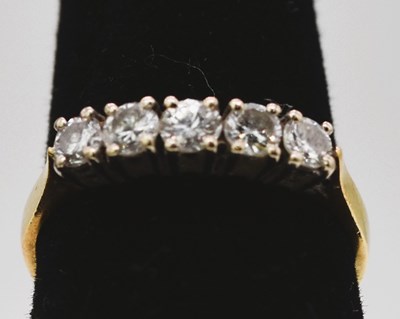 Lot 773 - An 18ct yellow gold five stone diamond ring,...