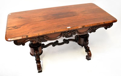 Lot 29 - A rosewood library table with carved frieze,...