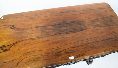 Lot 29 - A rosewood library table with carved frieze,...