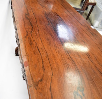 Lot 29 - A rosewood library table with carved frieze,...