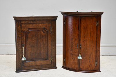 Lot 61 - A reproduction oak bowfronted corner cupboard...