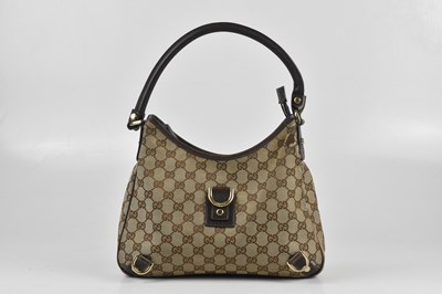 Lot 225 - GUCCI; a tan and brown monogram hobo style...