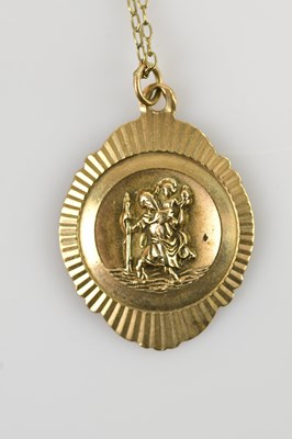 Lot 555 - A 9ct yellow gold St Christopher pendant,...