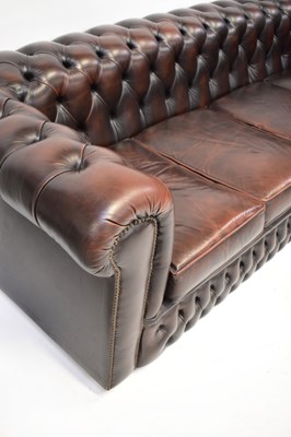 Lot 33 - CHESTERFIELD; a dark brown leather button...
