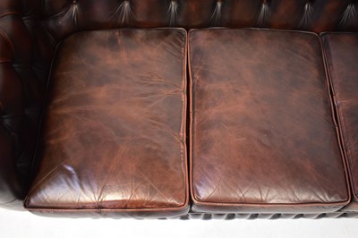 Lot 33 - CHESTERFIELD; a dark brown leather button...
