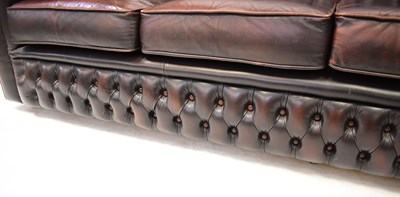 Lot 33 - CHESTERFIELD; a dark brown leather button...
