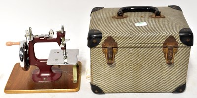 Lot 624 - A child's hand operated sewing machine mounted...