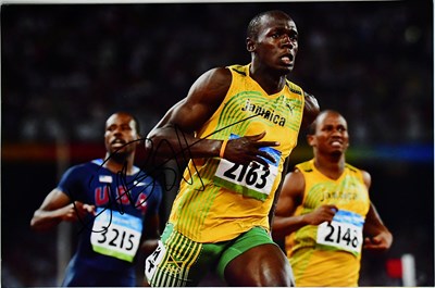 Lot 643 - USAIN BOLT; three signed colour photographs,...