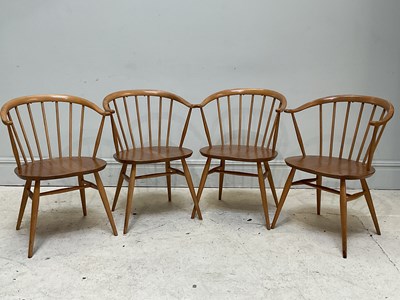 Lot 14 - ERCOL; a set of four light elm cowhorn dining...