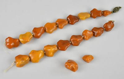 Lot 2226 - Two butterscotch amber coloured beaded...