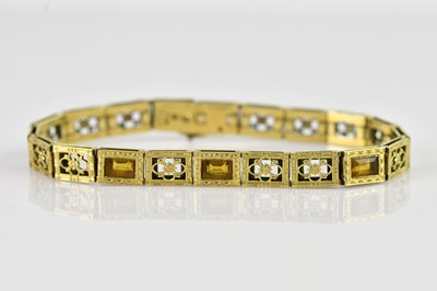 Lot 1256 - A yellow metal bracelet, set with seventeen...