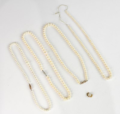Lot 1002 - Four pearl single strand necklaces, two...