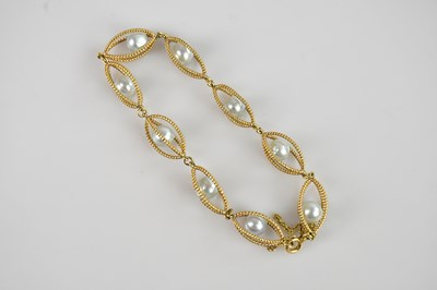 Lot 1166 - A yellow metal and pearl set openwork bracelet,...