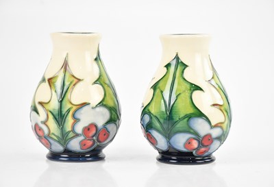 Lot 1600 - MOORCROFT; a pair of vases in the 'Holly'...