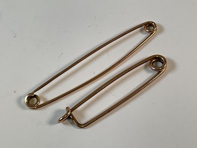 Lot 779 - Two 9ct gold cloak pins, one marked, one...