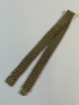 Lot 783 - An antique yellow metal broad mesh link...