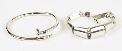 Lot 830 - A solid silver bracelet in the style of a nail,...