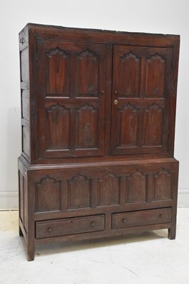 Lot 176 - An 18th century oak livery cupboard with two...