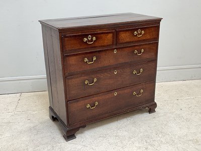 Lot 39 - A George III oak chest of two short above...