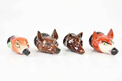 Lot 1698 - Four Staffordshire fox head stirrup cups,...