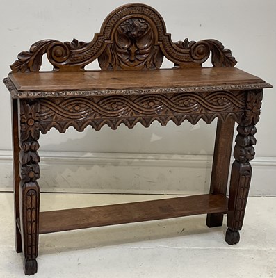 Lot 262 - A 1920s carved oak side table, with central...