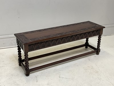 Lot 153 - A reproduction carved oak bench with hinged...