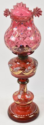 Lot 126 - A Victorian ruby glass oil lamp with painted...