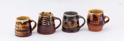 Lot 624 - RUSSELL KINGSTON; four slipware mugs, tallest...