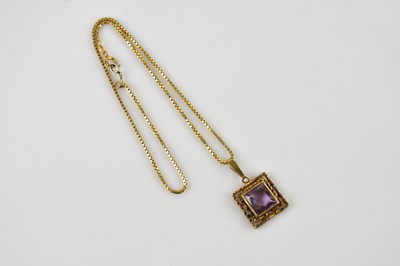 Lot 537 - A textured yellow metal pendant stamped 9C set...