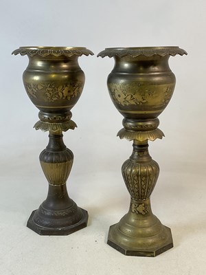 Lot 310 - A pair of brass jardinières on a decorative...