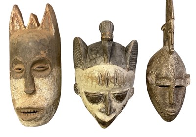 Lot 1019 - Three African tribal carved wooden masks,...