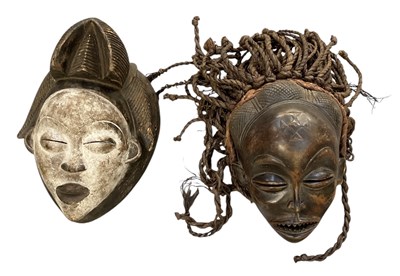 Lot 1014 - Two African carved wooden tribal masks,...