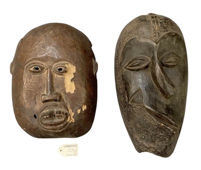 Lot 1001 - Two African carved wooden masks comprising an...