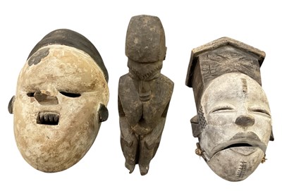 Lot 1011 - A West African carved wooden tribal carving of...