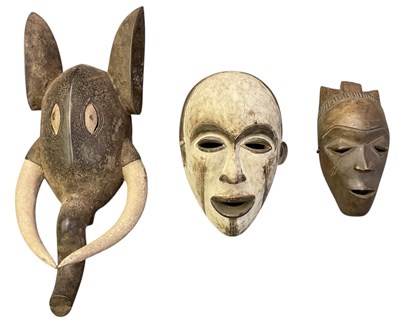 Lot 1013 - Three African carved wooden tribal masks...