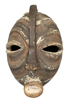 Lot 1045 - An African carved wooden tribal ceremonial or...